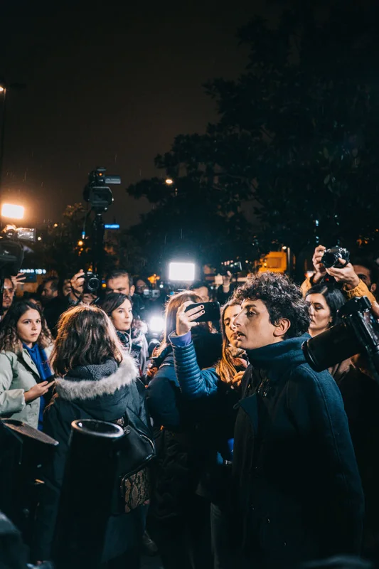 Press briefing with multiple media microphones and broadcast cameras